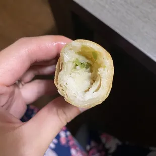 a person holding a piece of food