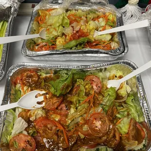 Salad with ginger dressing on one and peanut dressing on the other one.