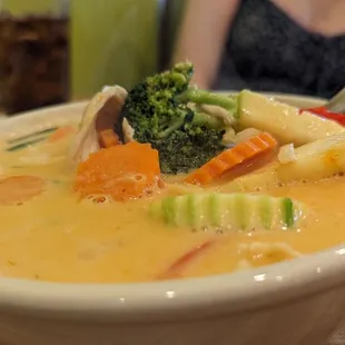 a bowl of soup with broccoli