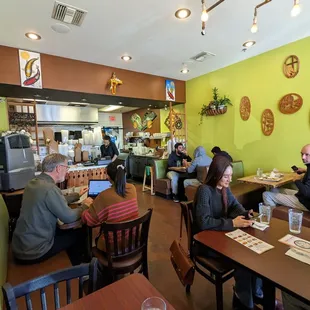 customers sitting at tables and eating