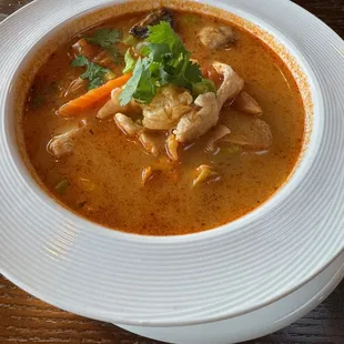 Tom Kha Coconut milk soup with galangal, lemon grass, mushroom, tomato and kaffir leaves
