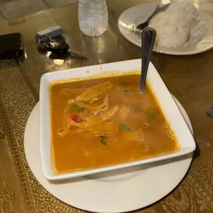 a bowl of soup with a spoon in it