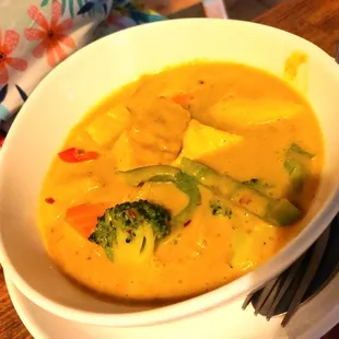 a bowl of soup with broccoli