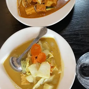 two bowls of soup and a glass of water