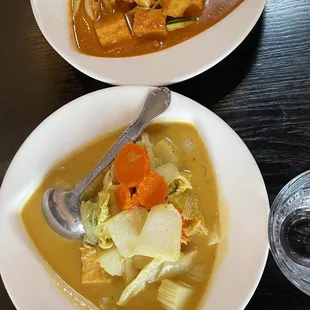 two bowls of soup and a glass of water