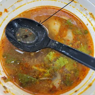 a spoon in a bowl of soup