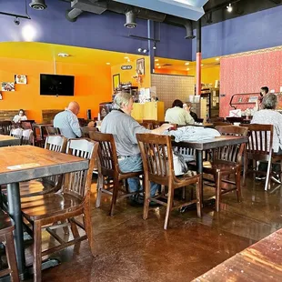 people sitting at tables in a restaurant