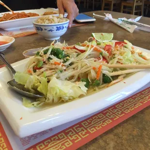 Papua salad swimming in vinegar with a bed of iceberg.