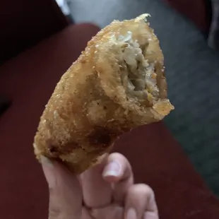 a hand holding a pastry