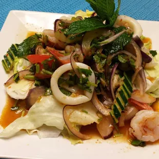 shrimp, lettuce, and vegetables on a white plate