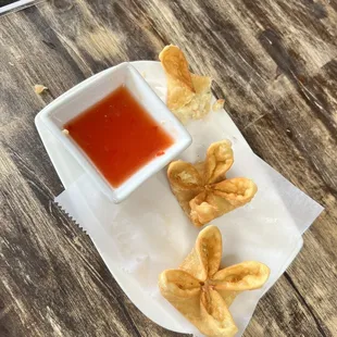 a plate of fried food with dipping sauce