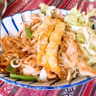 a plate of noodles with meat and vegetables