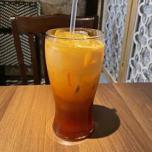 a glass of iced tea on a table
