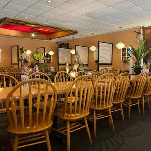 a large dining room with wooden chairs