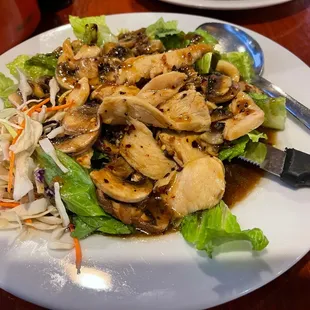a plate of chicken and salad