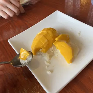 In the middle of eating yummy sticky rice topped with mango! A must-have after dinner.