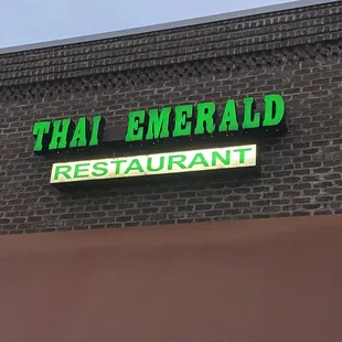 neon sign on brick building