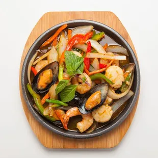 a bowl of stir fry with shrimp and vegetables