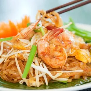 a plate of food with chopsticks