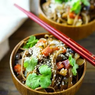 two bowls of noodles with chopsticks