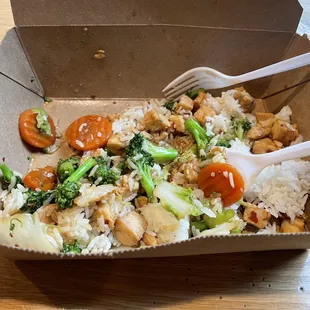a takeout box with rice and vegetables