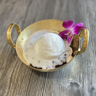 Coconut Ice Cream served with black sweet rice underneath.