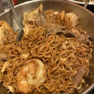 a bowl of noodles with meat and shrimp