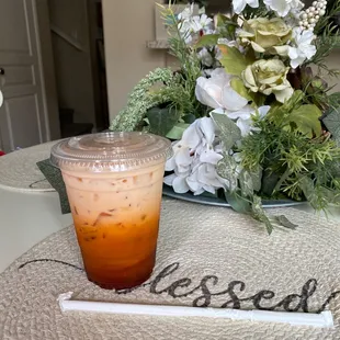 a drink in a plastic cup on a table