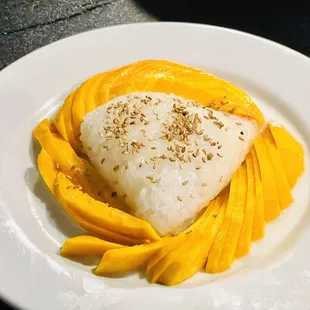 a plate of rice and mangoes