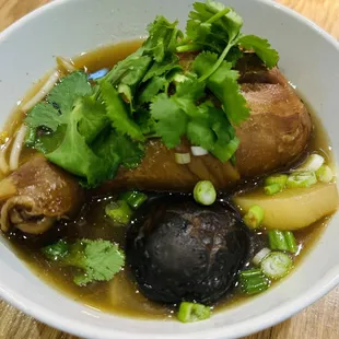 a bowl of soup with meat and vegetables