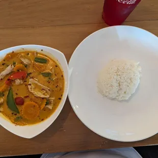 a bowl of rice and a bowl of chicken curry