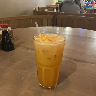 a glass of iced coffee on a table