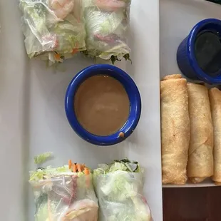 a plate of rice rolls and dipping sauce