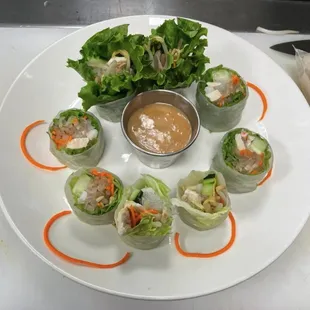 a plate of rolls with dipping sauce