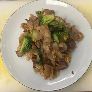 beef and broccoli on a white plate