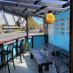 the outside of a restaurant with tables and chairs