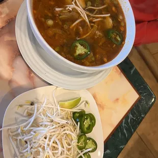 a bowl of soup and a plate of veggies