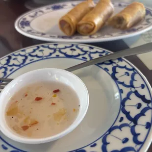 Homemade sweet n sour sauce with spring rolls.