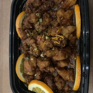 a chicken dish with orange slices