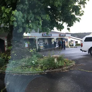 Their sign is right behind the tree. Look for the tattoo shop.