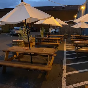 tables and umbrellas in a parking lot