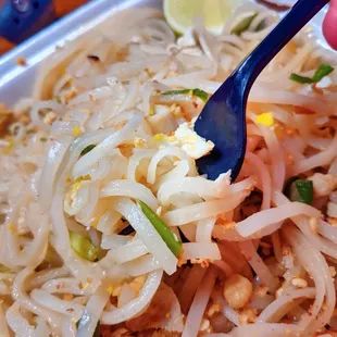 a person holding a fork over a plate of food