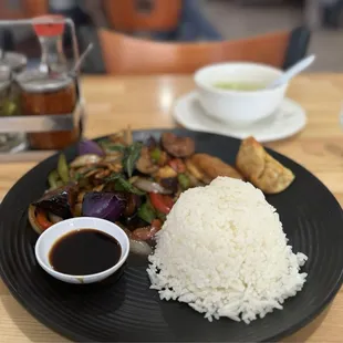 Lunch special. Eggplants with chicken. Clear soup. Spice rack on the side. So yummy!