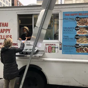 a woman ordering food from a food truck