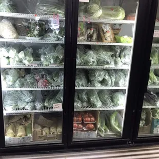 Refrigerators in back of store against the wall