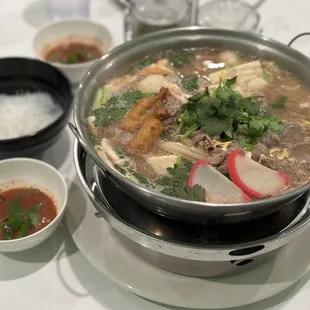 a bowl of soup and bowls of rice