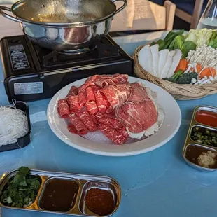 Hot pot with beef platter and veggie combo.