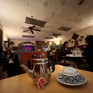 a teapot and a cup on a table