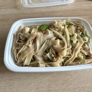 a plate of noodles and meat