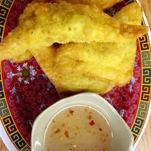 a plate of food with dipping sauce